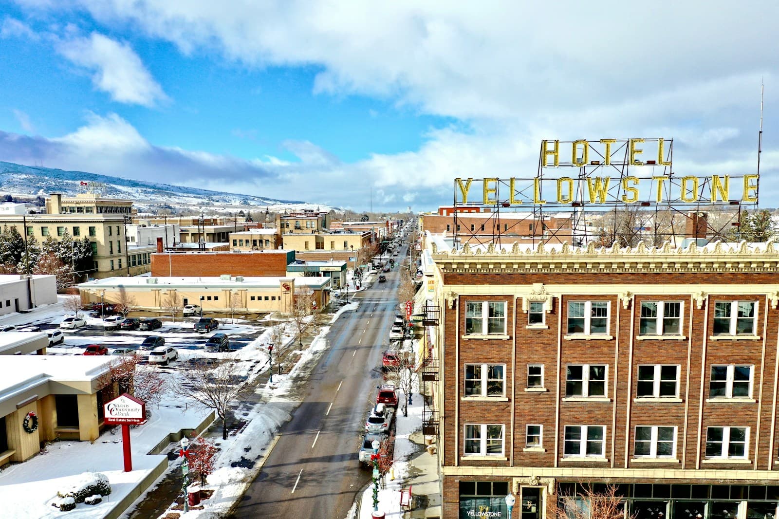 Aerial view of snowy downtown street with historic Hotel Yellowstone building and vintage Western architecture