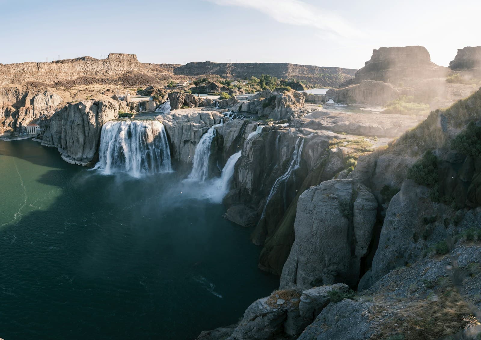 Shoshone Falls waterfall cascading over rocky cliffs into turquoise water in desert canyon landscape